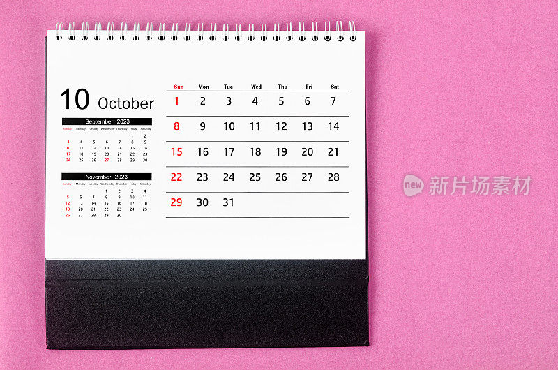 The October 2023 Monthly desk calendar for 2023 year on pink color background.